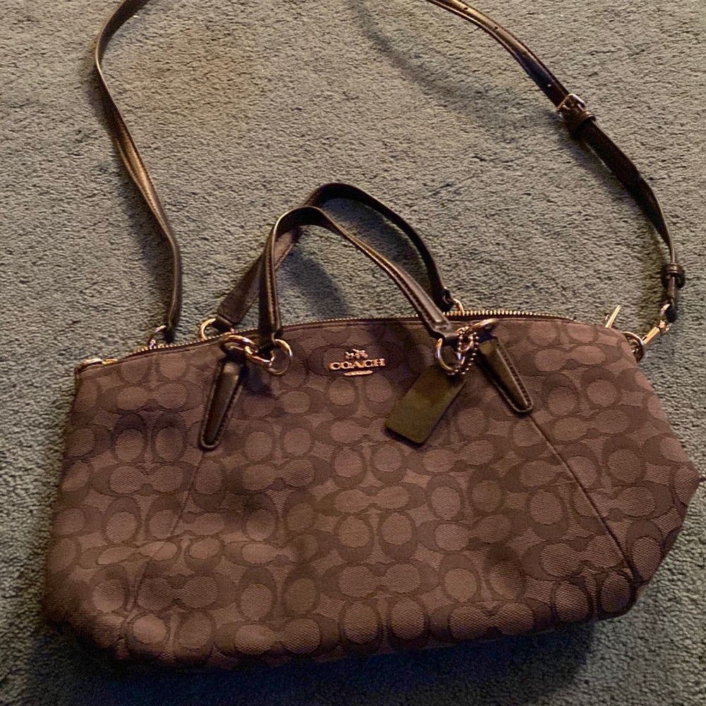 Coach gray with black emblems and handles crossbody handbag.